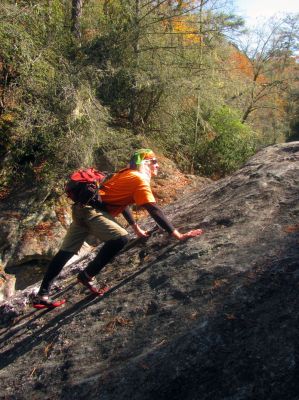 Profile of The Badger, extreme mountaineer as he climbs a steep rock face to gain access to the upper end of the slot canyon 
