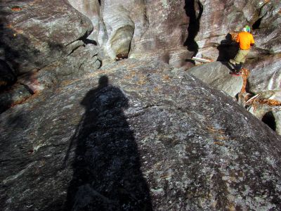 Looking down into the upper end of the slot canyon as Badger makes his way down the gut into the slot where I would soon join him. 
