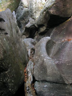 Me climbing up towards the top of the blockage rock . I can see the log at the top right coming into view. I could not wait to look down upon the other side where we had been previously 

