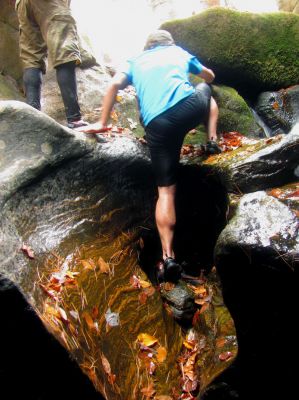 Tyler climbs up from the base of the slot canyon falls 
