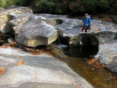 Tyler plays in a small pothole 
