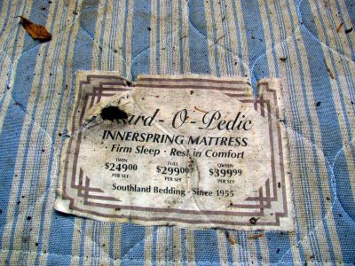 old mattress on side of road 
