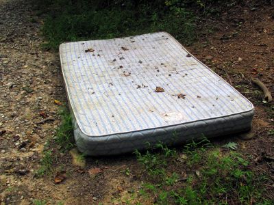 old mattress on side of road
