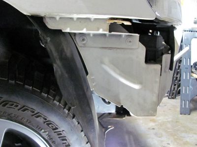 Pass side. That piece of metal is usually completely removed on these type of jobs but, I decided not to. I cut it and bent it over where the two horns are. I had to modify the horns position so that the wires came down from top instead of sticking out the back which worked well. 
