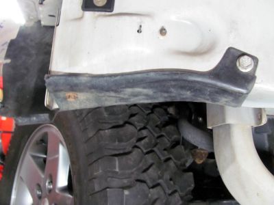 I manipulated the inner fender and wrapped it around the horns and screwed it to the front metal bumper 
