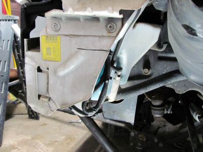 Driver side has a windshield washer fluid reservoir that is definitely in the way. if you are planning on serious off roading this MUST be removed completely. If you still need one you can get on out of an XJ that mounts up near the brake master cyl that uses the same plug ins etc. 
