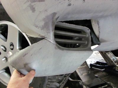 First I cut out a large slot in the lower end of the bumper cover 
