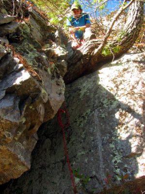 Tyler already halfway up the crack , as he is perched upon the large pine tree root. He is waiting to help me get back up as he knows I will need it ! 
