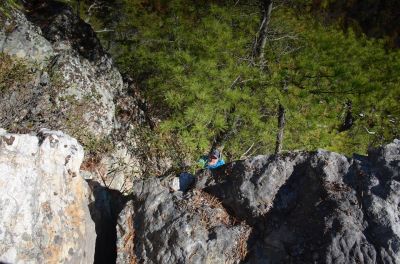 Me, the RAT, in the crack, standing on the pine tree root as it is the only place you can do so (Photo by Larry Jarret) 
