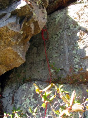 the rope hanging down from the crack 
