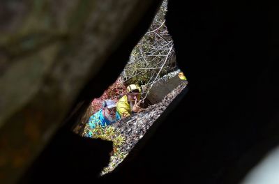 John and myself as we stand on 'the ledge some 60 feet below the summit of the cliffs as seen through the small hole in top of the cliffs by Larry Jarret. (Photo by Larry Jarret) 

